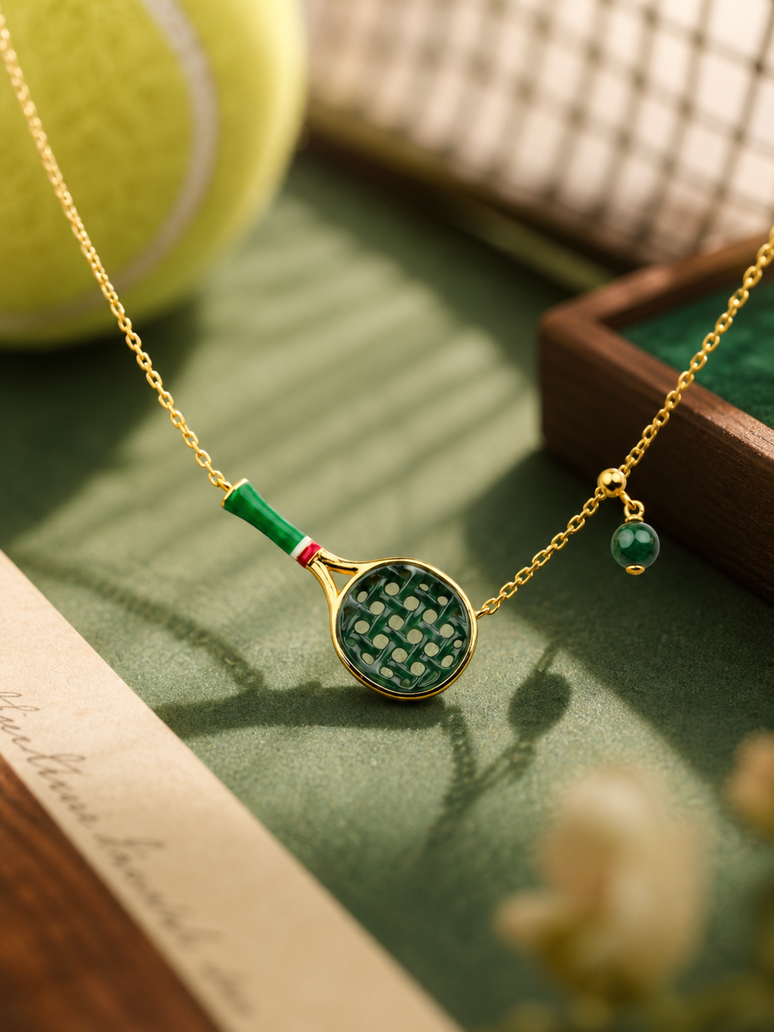 Close-up of natural jadeite tennis racket pendant and jade bead